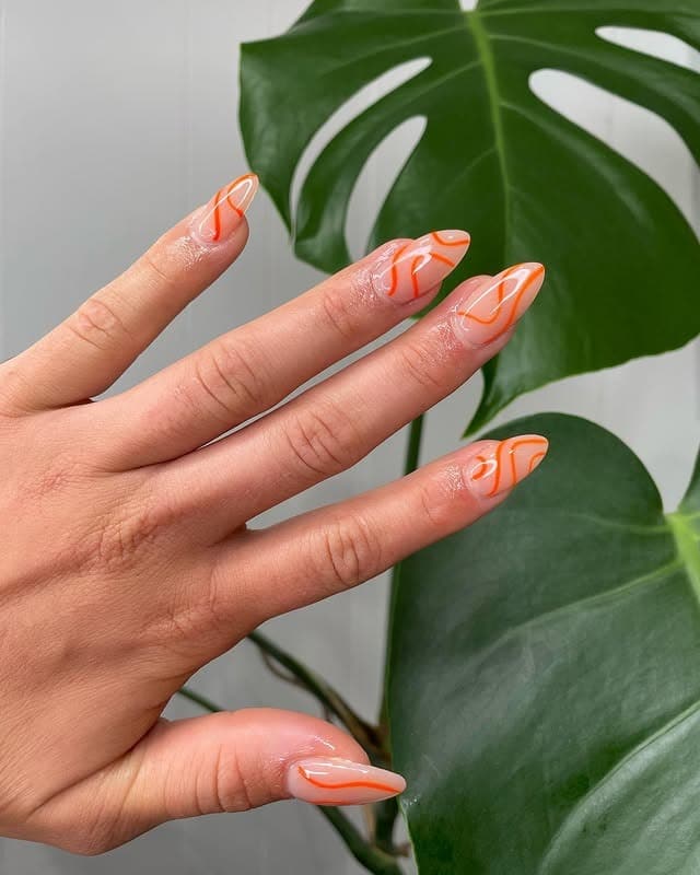 5. Peach Nude Almond Nails with Orange Abstract Lines - lines nail ideas