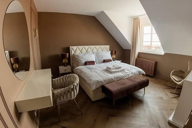 4. Warm Taupe Attic Bedroom with Cozy Layers - brown bedroom ideas