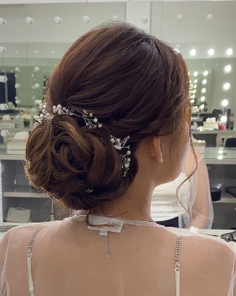 10. Polished Twisted Low Bun with Subtle Brown Highlights - Low Messy Hair Bun