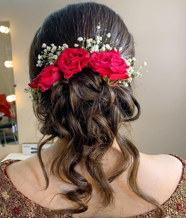 11. Romantic Low Bun with Red Floral Accents and Rich Brunette - Low Messy Hair Bun