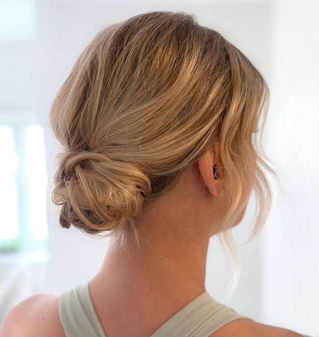 19. Classic Low Bun with Warm Blonde Layers - Low Messy Hair Bun
