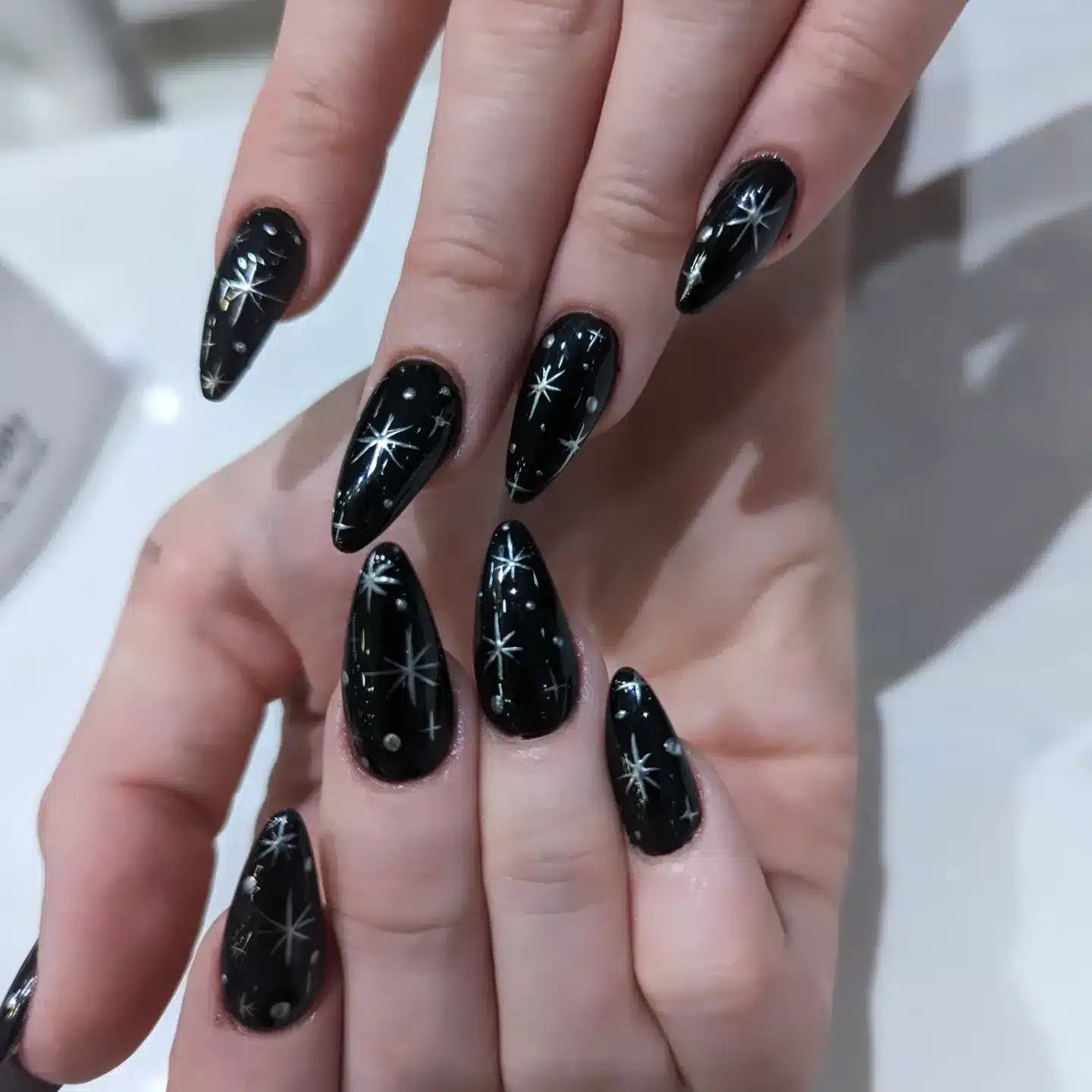 5. Black Galaxy Star Almond Nails - black nail ideas