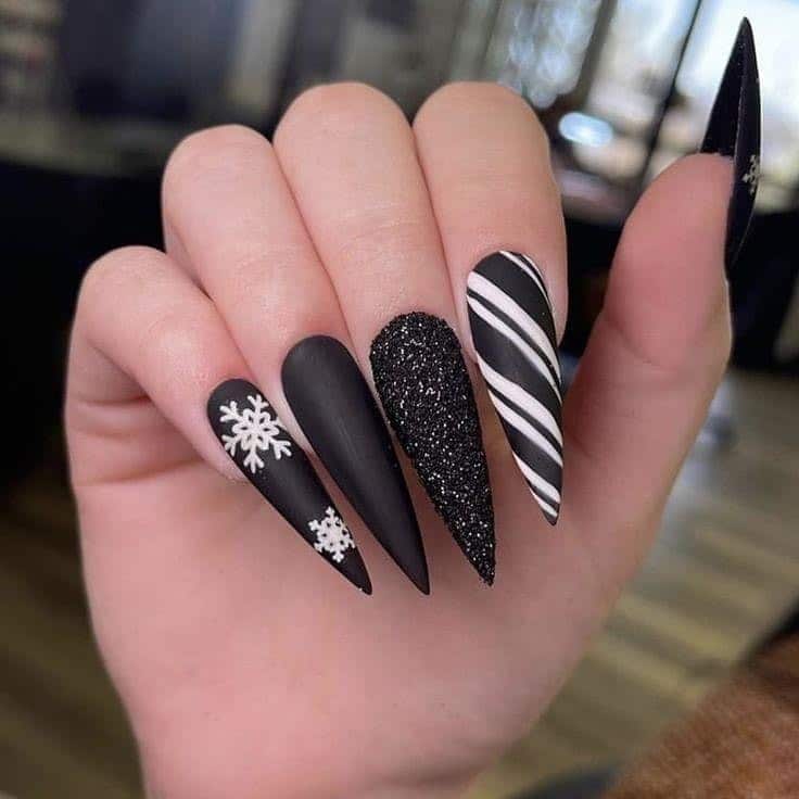 8. Matte Black and Glitter Snowflake Stiletto Nails - black nail ideas