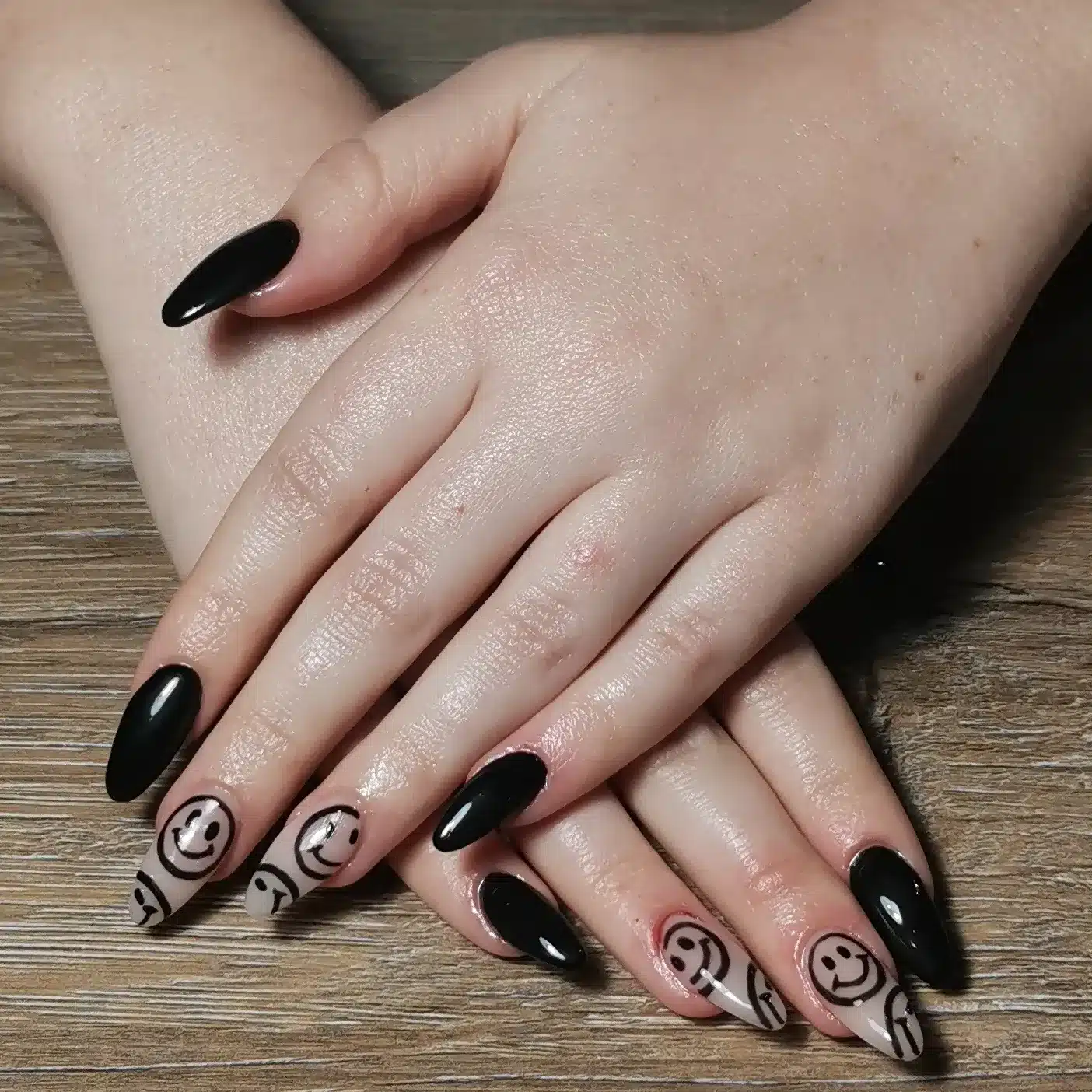 13. Black Almond Nails with Smiley Face Art - black nail ideas