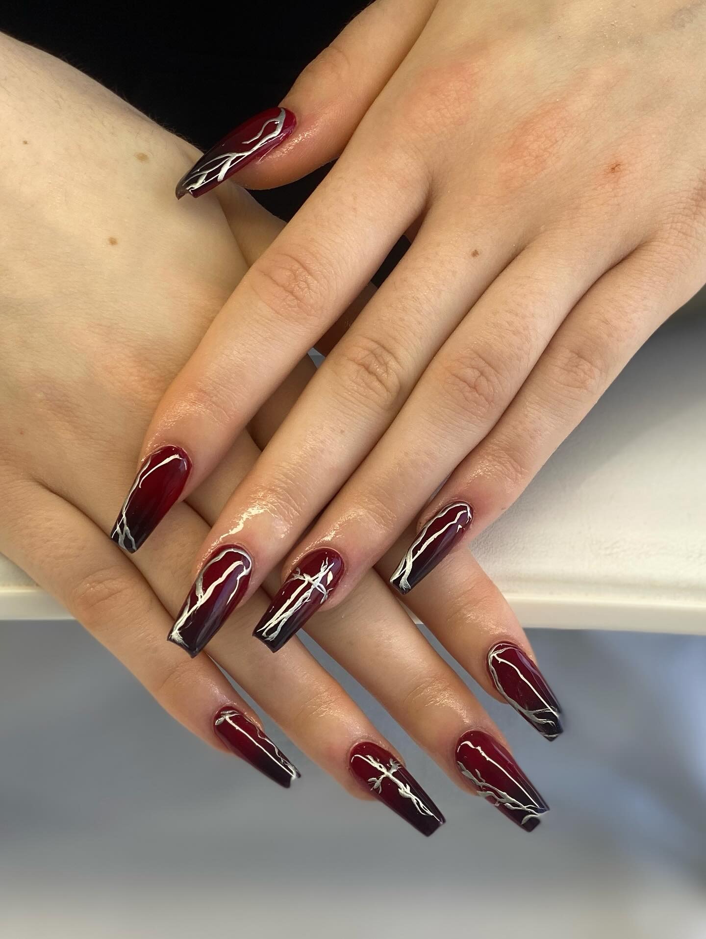 21. Deep Burgundy Coffin Nails with White Abstract Line Art - dark coffin nail ideas