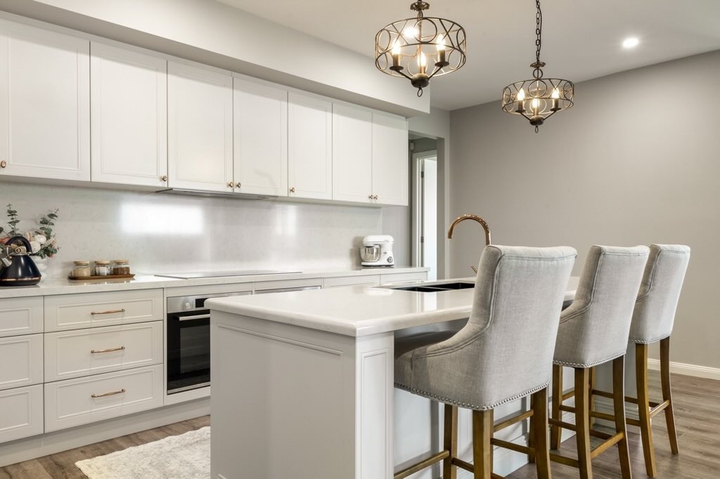 4. Elegant Cream Kitchen with White Countertop Island - white countertop kitchen ideas