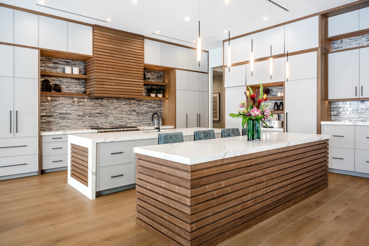 5. Contemporary White Countertop Kitchen with Wood Texture Panels - white countertop kitchen ideas