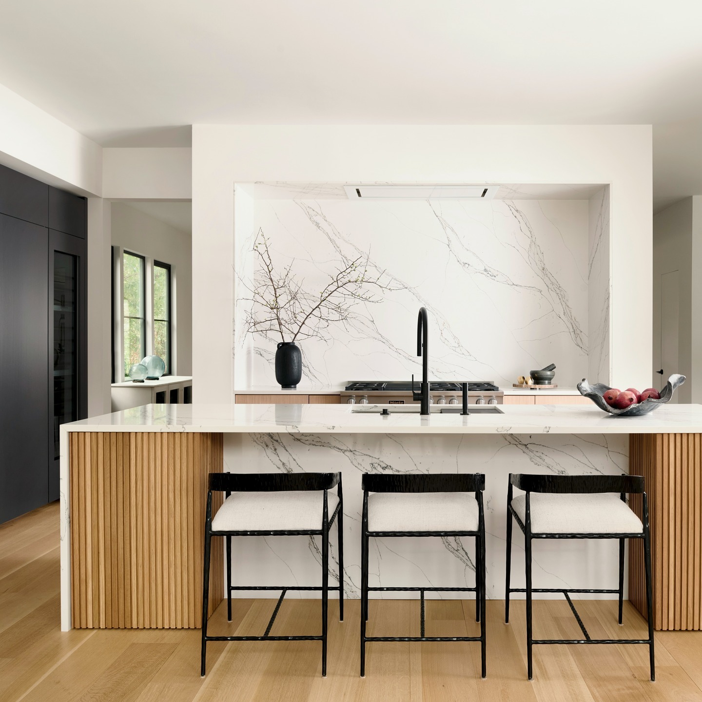 12. Modern White Countertop Kitchen with Marble Veining and Natural Oak - white countertop kitchen ideas