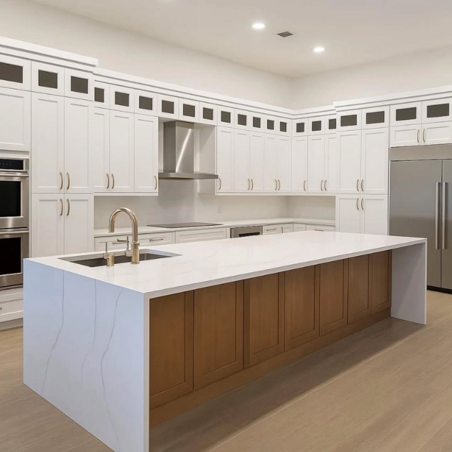20. Classic White Kitchen with Waterfall Countertop and Wood Base Island - white countertop kitchen ideas