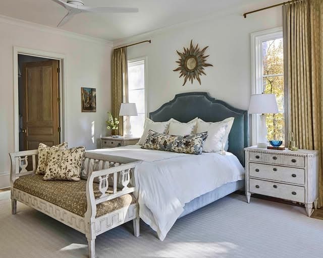 20. Traditional White Bedroom with Blue Upholstered Headboard and Antique Details - white wall bedroom ideas