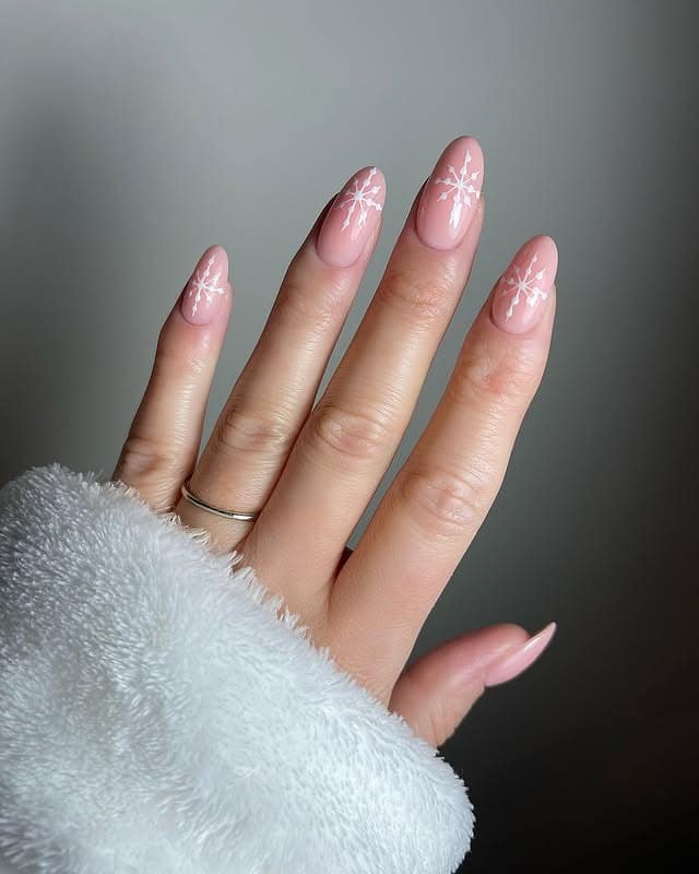 8. Soft Pink Almond Nails with White Snowflake Art - minimalistic nail ideas