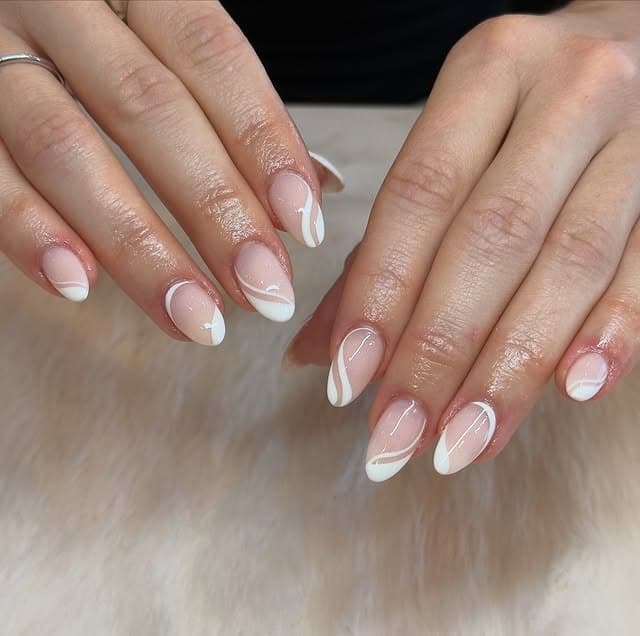 16. Sheer Nude Almond Nails with Soft White Swirls - minimalistic nail ideas