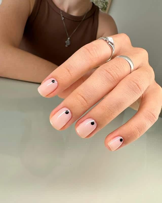 21. Sheer Nude Short Nails with Black Dot Accents - minimalistic nail ideas