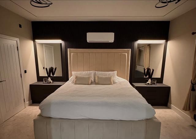 2. Black Accent Wall Bedroom with Framed Mirror Symmetry - bedroom ideas with mirror