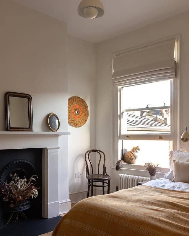 13. Warm Neutral Bedroom with Fireplace Character - small guest bedroom ideas