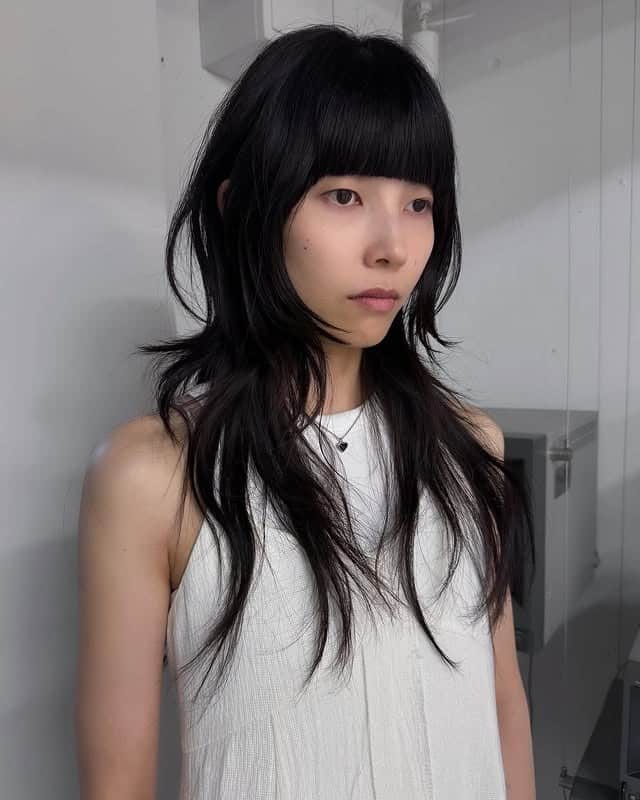 8. Layered Black Shag with Soft Curtain Bangs - Layered Shaggy Hairstyles