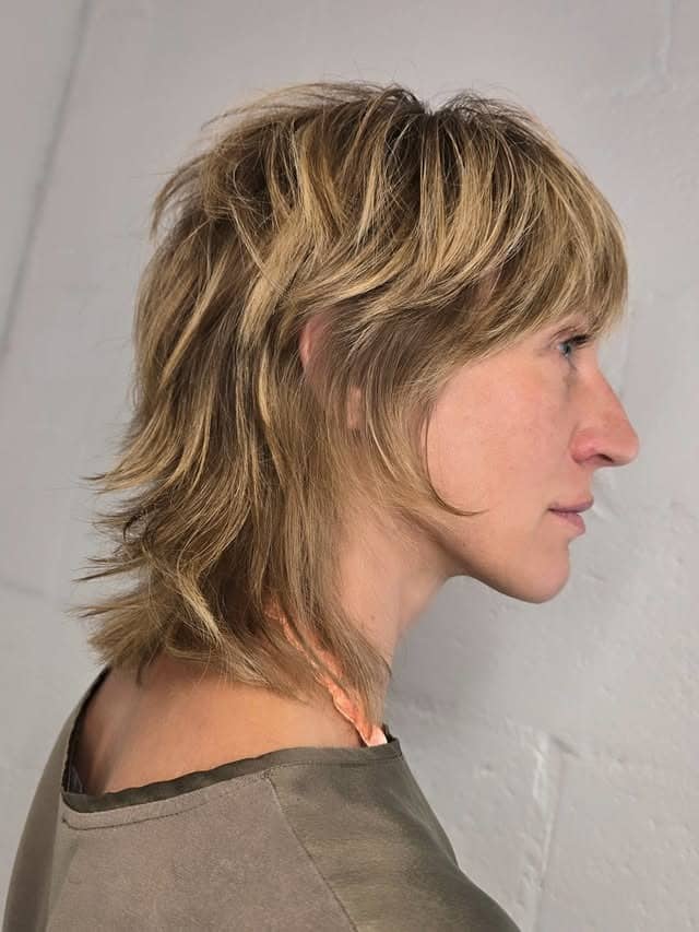 20. Golden Blonde Feathered Shag with Layered Crown - Layered Shaggy Hairstyles
