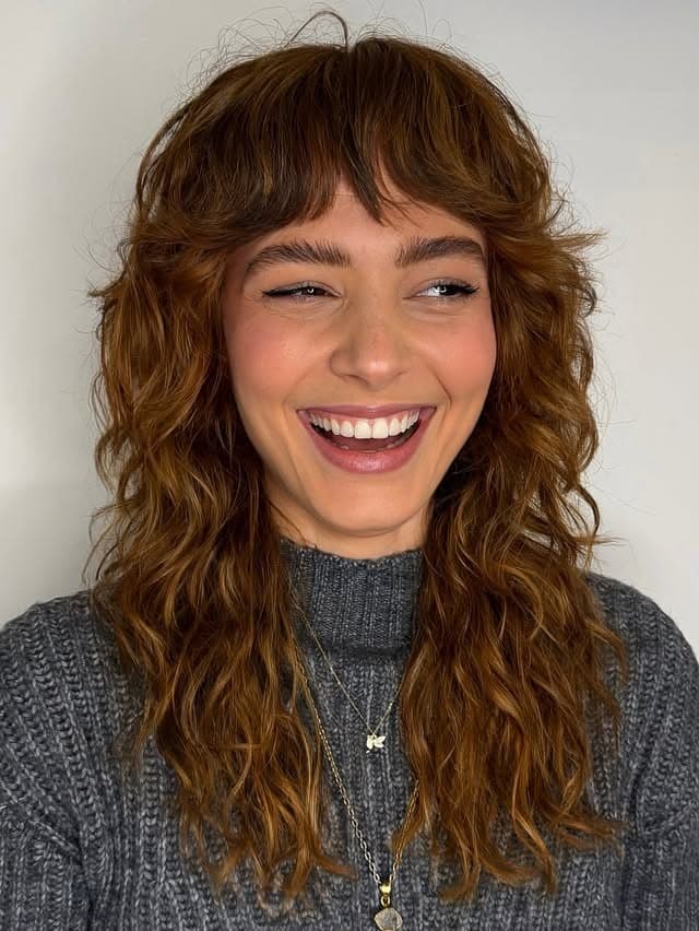 10. Golden Brown Curly Shag with Wispy Bangs - Short Shaggy And Wispy Haircuts
