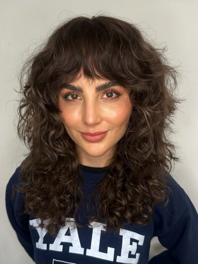 11. Voluminous Chocolate Brown Curly Shag with Wispy Fringe - Short Shaggy And Wispy Haircuts