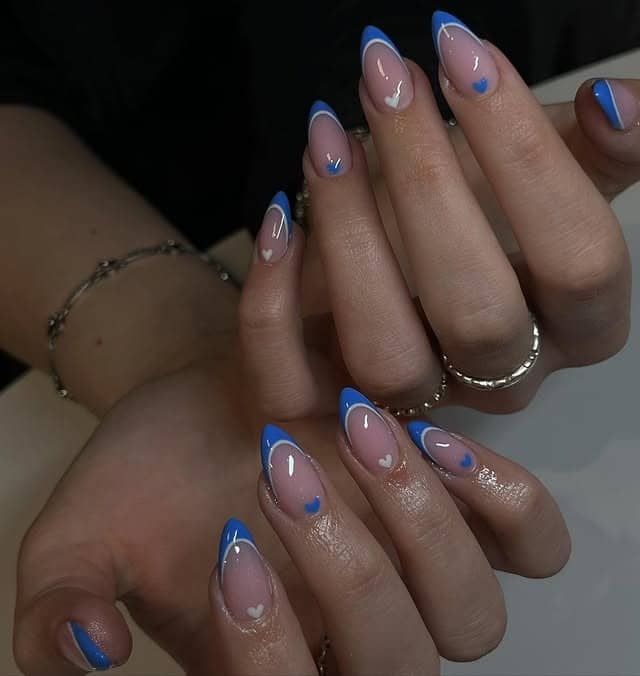 11. Blue French Tip Almond Nails with Heart Accents - blue nail ideas