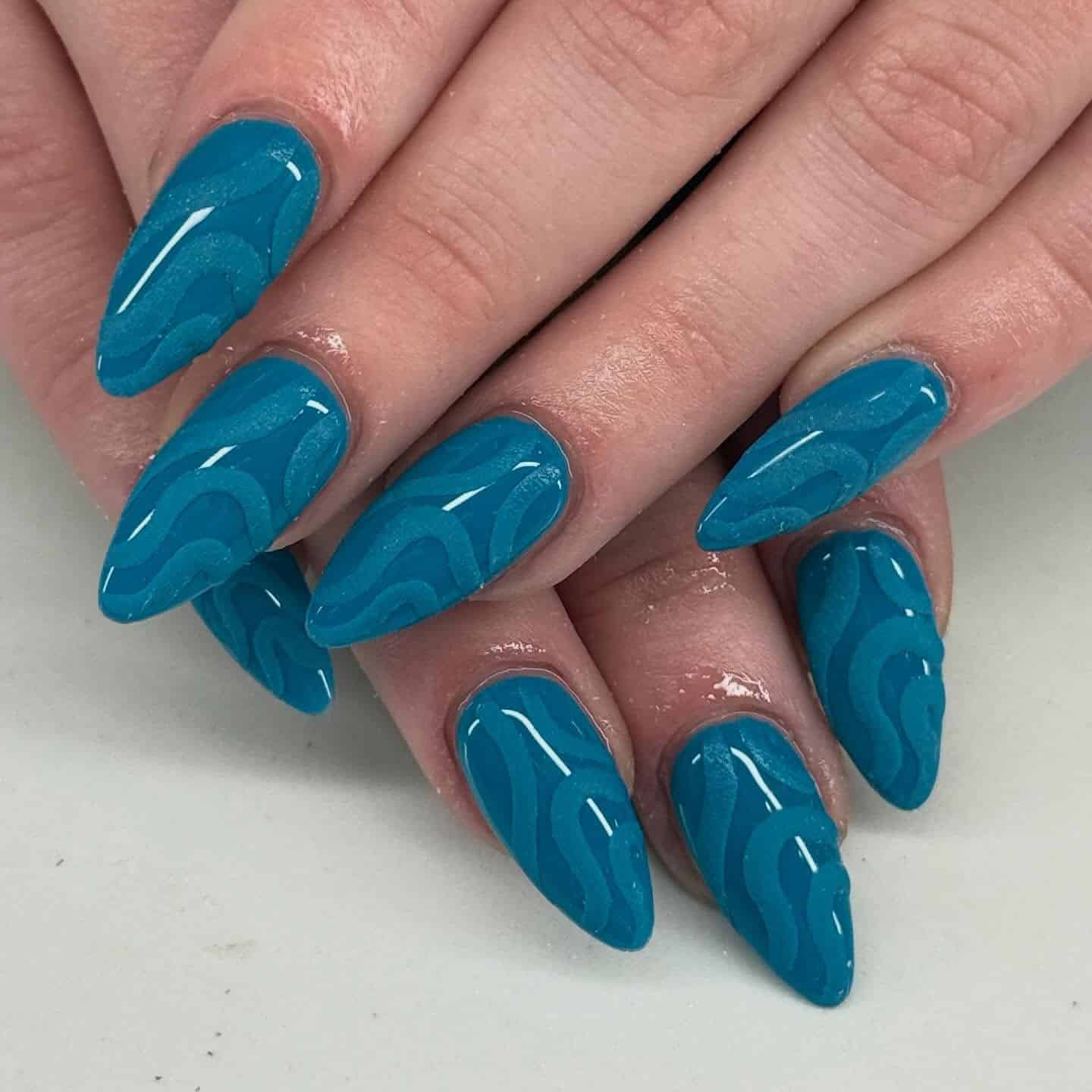 15. Teal Wave Almond Nails - blue nail ideas