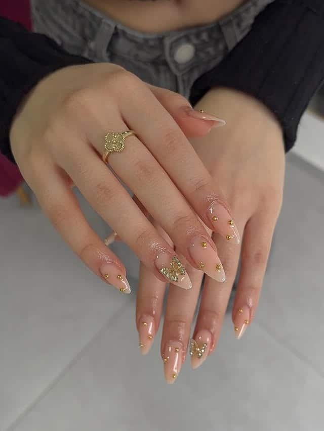 1. Nude Almond Nails with Gold Stud Detailing - nail ideas with gold