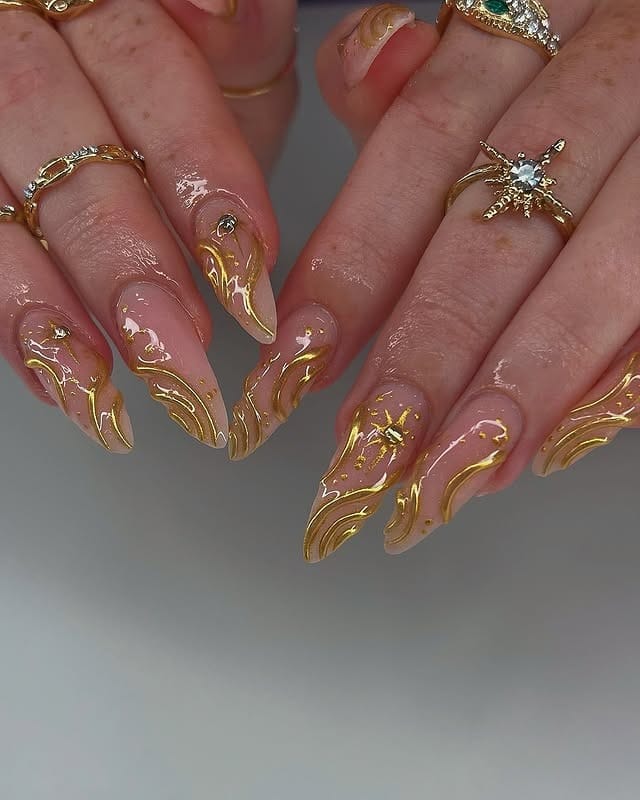 2. Sculpted Gold Swirl Stiletto Nails - nail ideas with gold