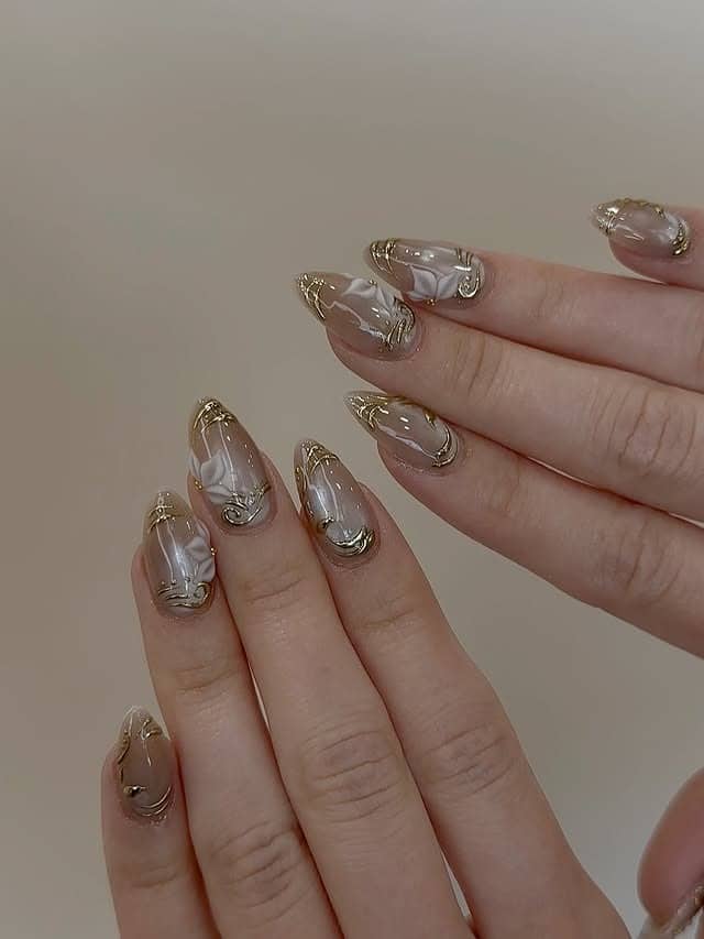 7. Milky Marble Almond Nails with Gold Veining - nail ideas with gold