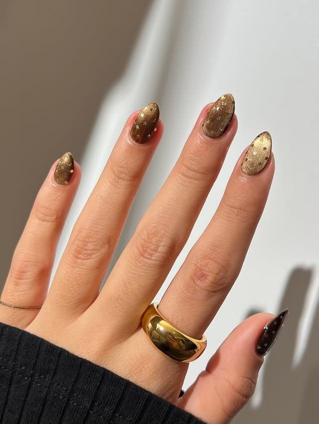 9. Gold Glitter Gradient Almond Nails - nail ideas with gold