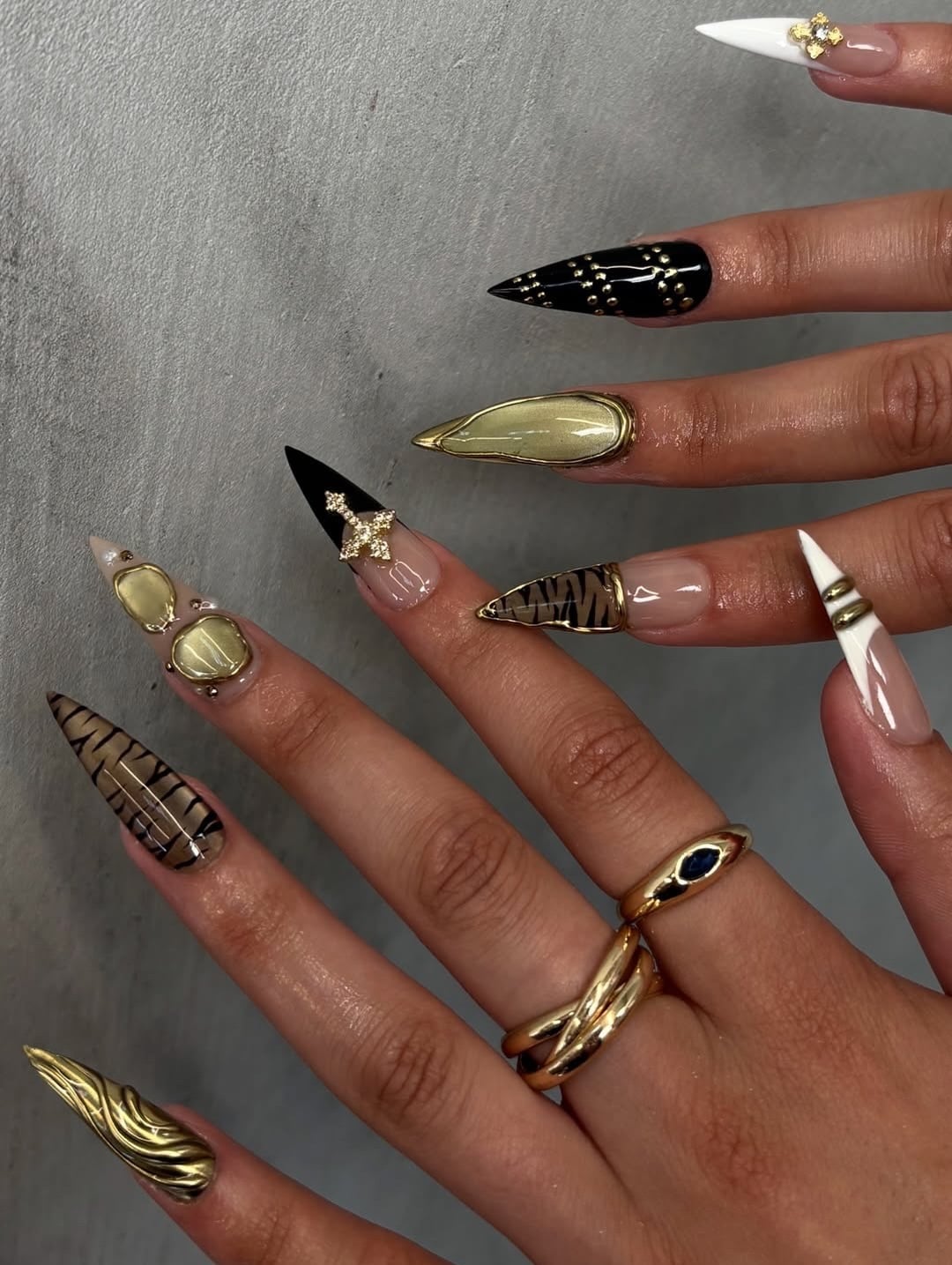 15. Mixed Design Stiletto Nails with Gold Chrome, Black Accents, and Animal Print - nail ideas with gold