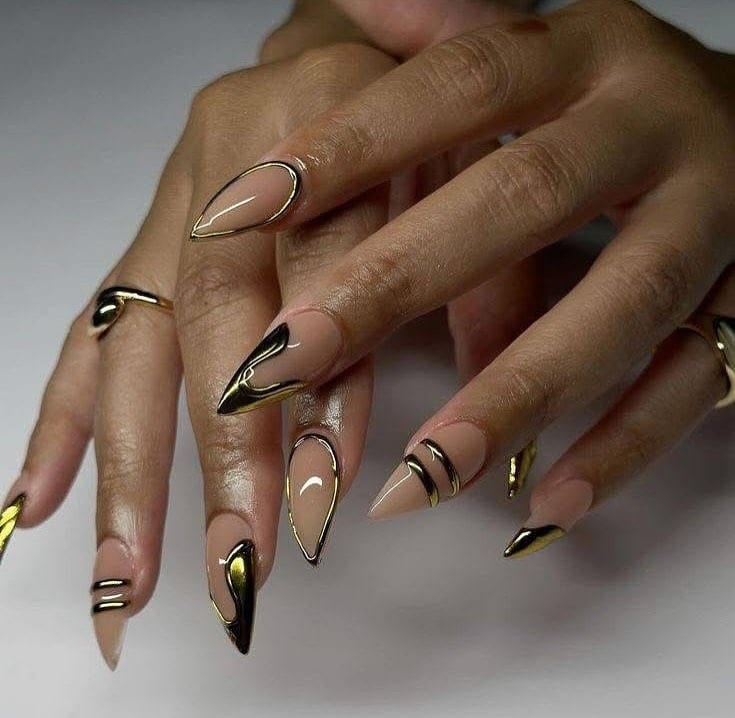 19. Nude Stiletto Nails with Black and Gold Metallic Detailing - nail ideas with gold