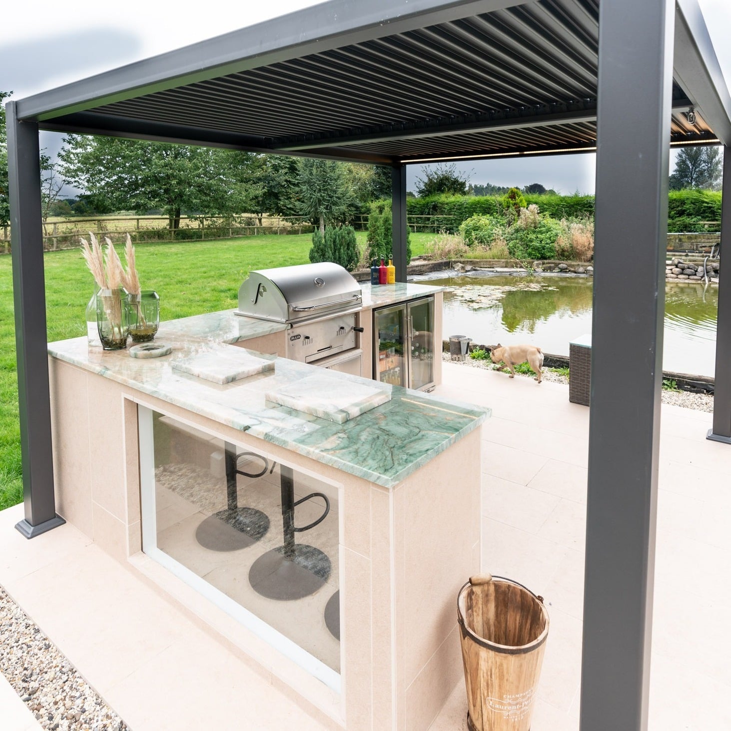 4. Sleek Pergola Kitchen with Green Marble Countertop and Scenic Views - outdoor kitchen ideas