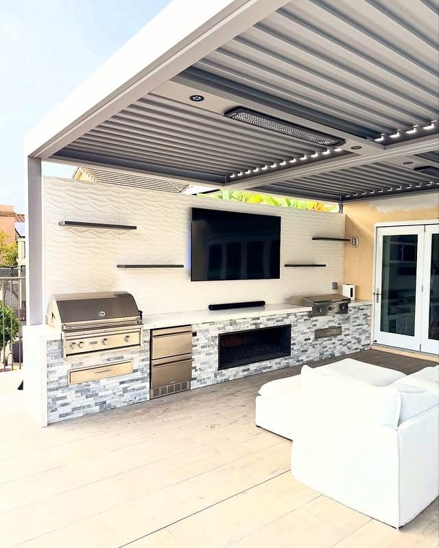 6. Luxury Entertainment Kitchen with Built-In Fireplace and Soft Gray Tones - outdoor kitchen ideas