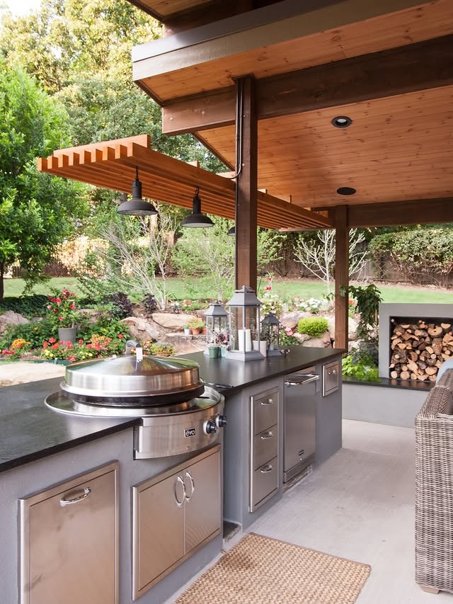 12. Warm Wood Outdoor Kitchen with Stainless Steel and Garden Views - outdoor kitchen ideas