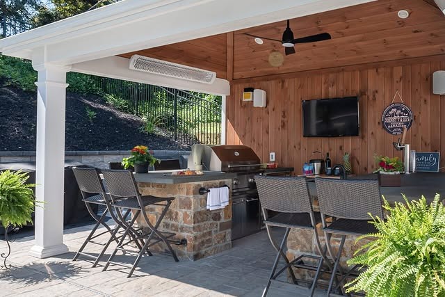 13. Classic Covered Patio Kitchen with White Trim and Natural Wood Backdrop - outdoor kitchen ideas