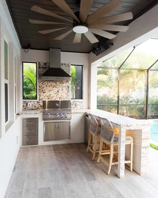 15. Compact Covered Kitchen with Neutral Finishes and Modern Fan Feature - outdoor kitchen ideas