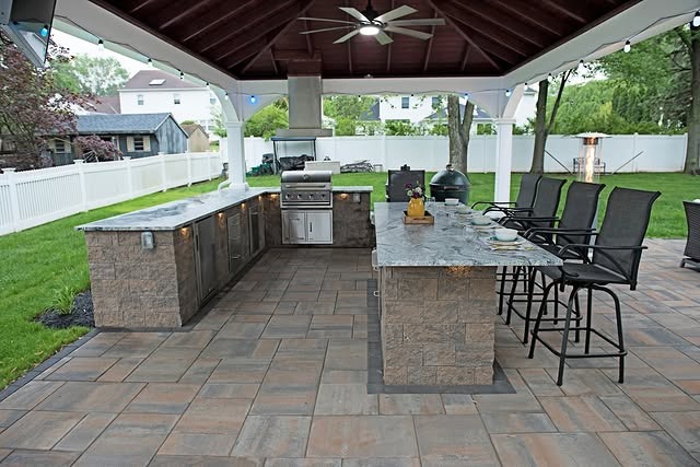 16. Spacious Pavilion Kitchen with Earthy Stone and Open Layout - outdoor kitchen ideas