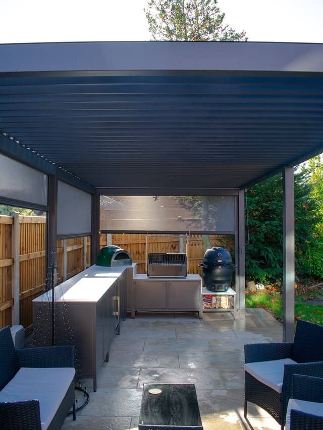 19. Modern Enclosed Pergola Kitchen with Dark Frame and Clean Lines - outdoor kitchen ideas