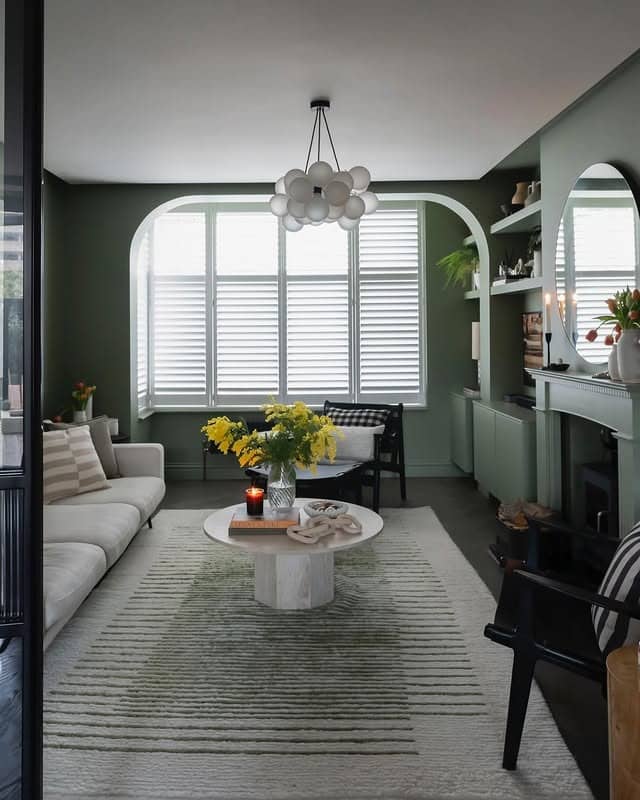 8. Muted Green Living Room with Contemporary Arched Features - green living room ideas