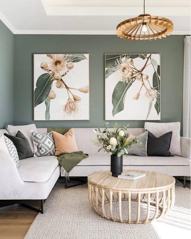 15. Soft Green Accent Wall Living Room with Botanical Artwork - green living room ideas