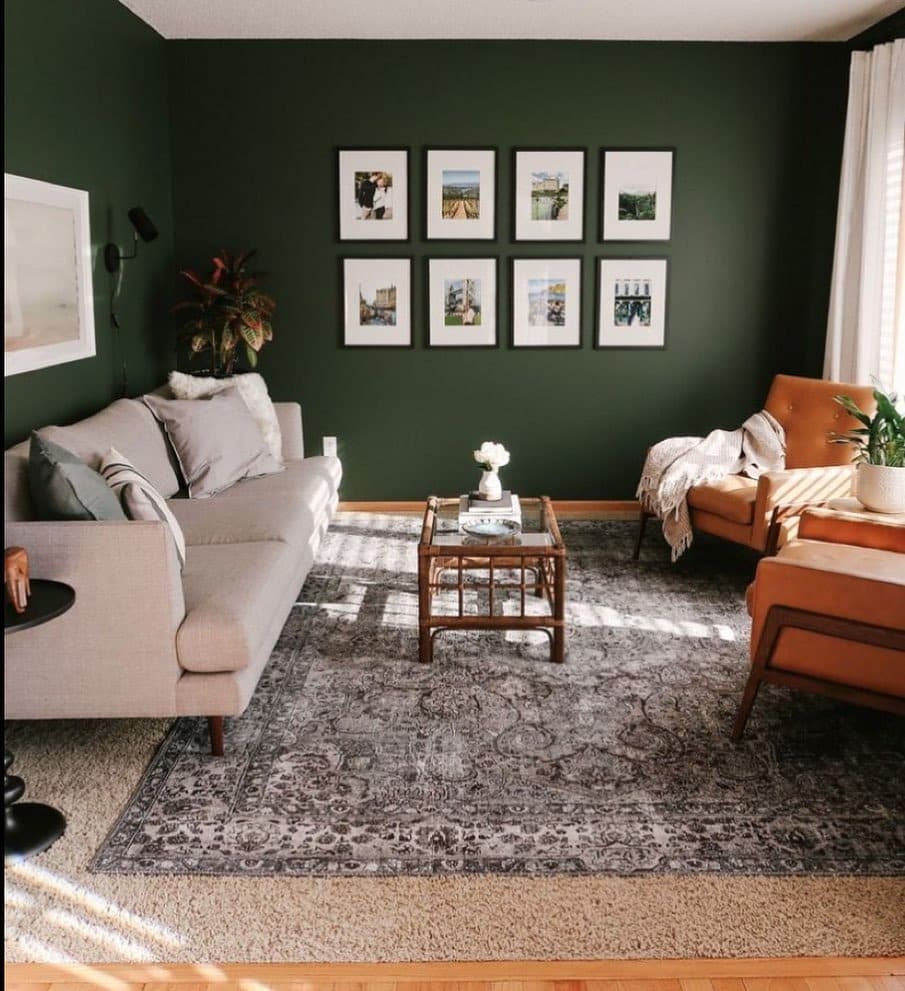 21. Dark Forest Green Accent Wall Living Room with Warm Leather Contrast - green living room ideas