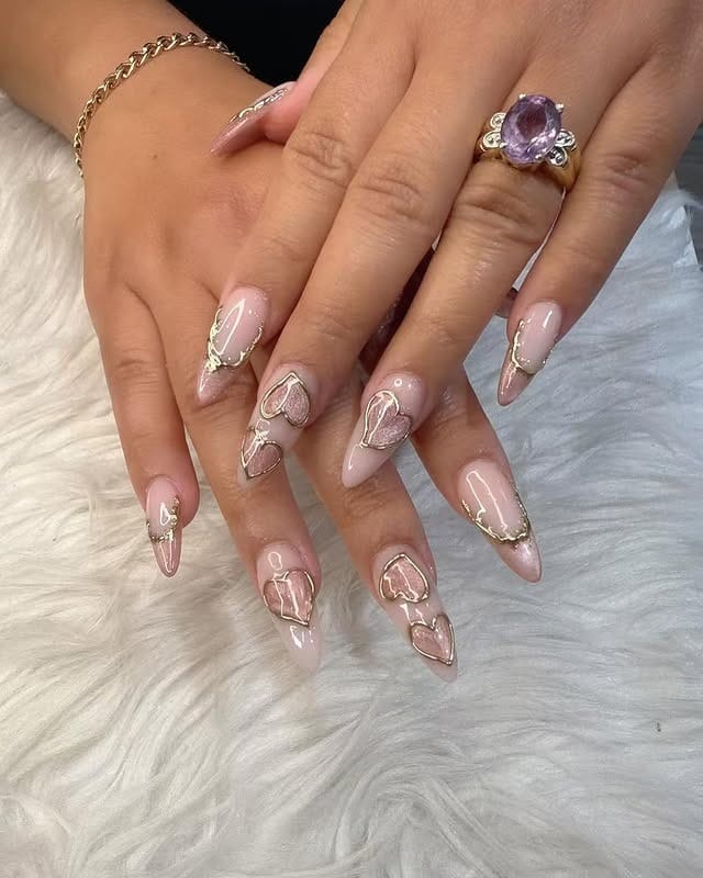 1. Blush Pink Stiletto Nails with Gold Heart Accents - bling nail ideas