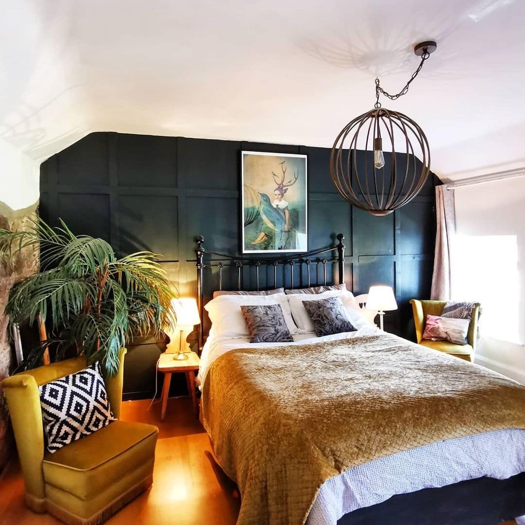 8. Moody Green Bedroom with Dramatic Paneling - eclectic bedroom ideas