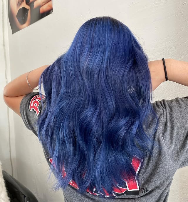 7. Deep Sapphire Blue Soft Waves - Smoky Blue Hair Color