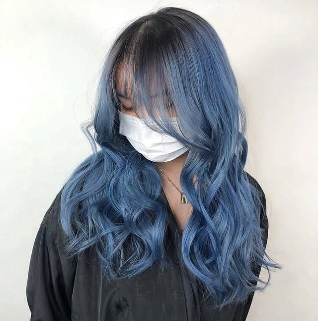 14. Powder Blue Smoky Balayage with Curtain Bangs - Smoky Blue Hair Color