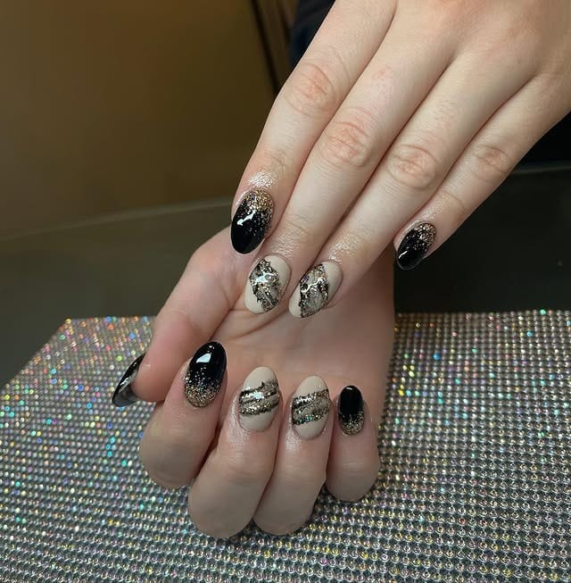 11. Black and Gold Glitter Gradient Almond Nails - homecoming nail ideas