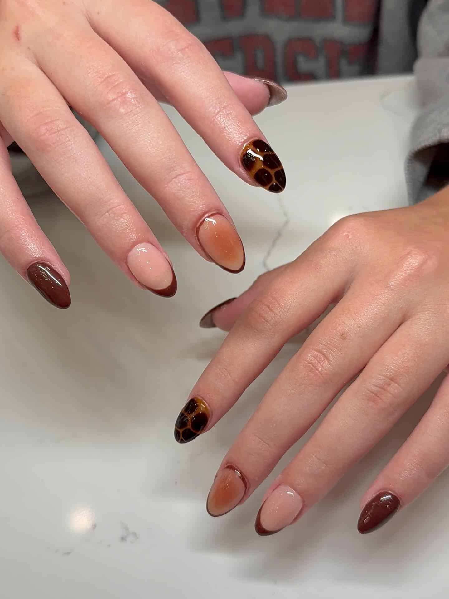12. Chocolate Brown Tortoiseshell Almond Nails - homecoming nail ideas