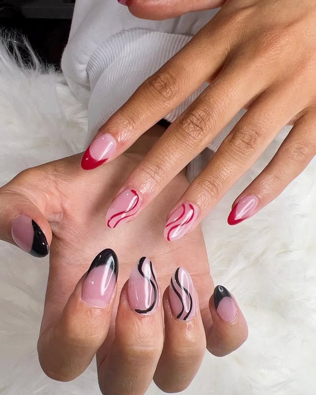 17. Black and Red Swirl French Almond Nails - homecoming nail ideas