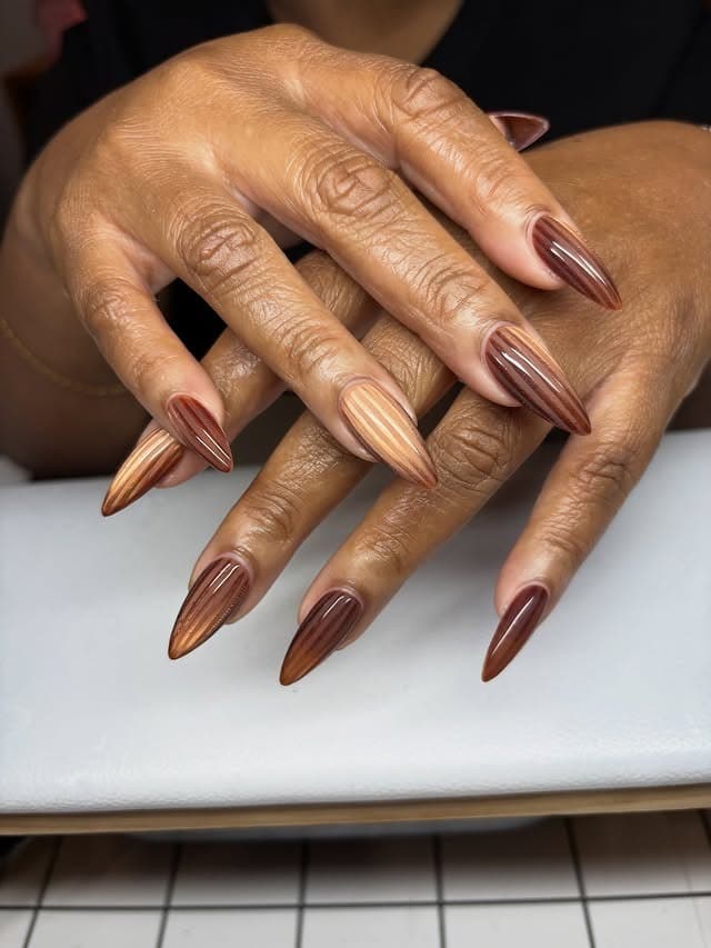 18. Metallic Bronze Striped Stiletto Nails - fall nail ideas