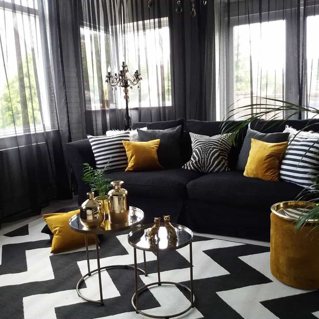 7. Black Sofa with Mustard and Patterned Accents - black sofa living room ideas